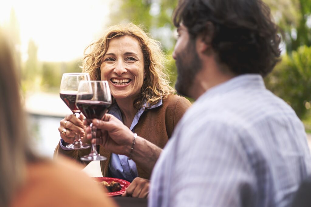 40s people having fun toasting outdoors